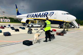 A security team inspects the luggage removed from the Ryanair flight diverted to Minsk on May 23, 2021