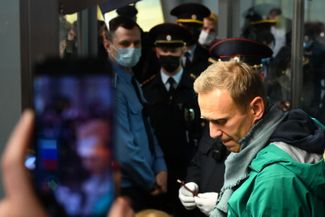 Navalny’s arrest at Sheremetyevo airport after returning to Moscow from Berlin. During his recovery in Germany, Russian prison officials issued an arrest warrant for Navalny, claiming that he had violated the parole terms of his probation sentence in the “Yves Rocher” case. The authorities filed a lawsuit demanding that his probation be revoked and replaced with a prison sentence. Navalny is jailed for a month, pending the results of the hearing. January 17, 2021.
