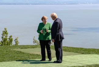Канцлер Германии Ангела Меркель и президент США Дональд Трамп на саммите «Большой семерки» в Квебеке, июнь 2018 года