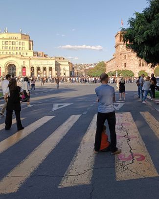 Protesters block the street in front of a government building in Yerevan