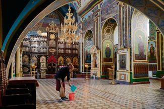 A worshiper cleans the floor of an Orthodox church in Bălți, Moldova. November 5, 2023.