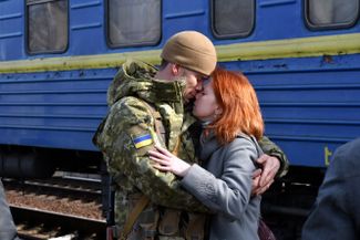 A couple parts at a rail station in Kramatorsk (400 miles southeast of Kyiv), before the woman boards a train to flee to safety in western Ukraine.