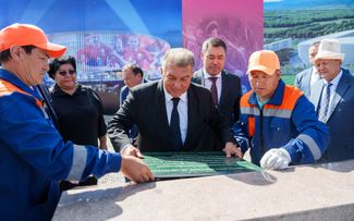 Kyrgyz President Sadyr Japarov watches as FC Barcelona president Joan Laporta lays the first brick in the new Kyrgyzstan National Stadium. August 2023. 
