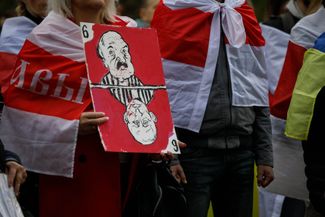 A poster showing caricatures of Alexander Lukashenko and Vladimir Putin at a protest held by Belarusian, Ukrainian, and Kazakhstani activists in Warsaw. October 30, 2022.