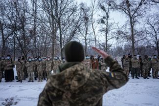 Members of the Territorial Defense Forces line up ahead of drills in Kharkiv