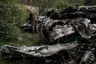 A Ukrainian soldier examines the wreckage of a Russian Su-34 in the city of Lyman in Ukraine’s Donetsk region. October 5, 2022.
