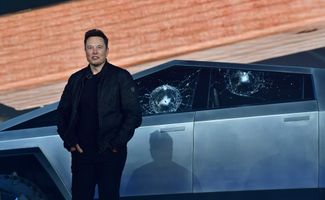 Tesla co-founder and CEO Elon Musk stands in front of the shattered windows of the newly unveiled all-electric battery-powered Tesla's Cybertruck at Tesla Design Center in Hawthorne, California. 