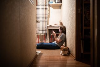 Egor can call for no longer than 15 minutes at a time, so in the evening, when he has access to a phone, he rings Dasha several times. In the photo, Dasha is waiting for his call.