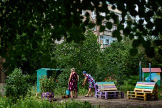 Жительницы Славянска набирают воду во дворе. Централизованное водоснабжение в городе не работает из-за того, что трубопроводы и другие линии коммуникаций пострадали в результате обстрелов