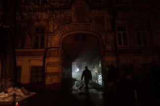People walk through downtown Kyiv, which was without electricity after Russian missile attacks on the city. Kyiv, Ukraine, Thursday, Nov. 24, 2022. 