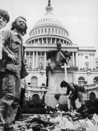 Американские ветераны войны во Вьетнаме складывают свои боевые награды у памятника первому председателю Верховного суда США Джону Маршаллу перед Белым домом. Вашингтон, 26 апреля 1971 года