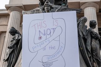 Плакат со словами «Это не собственность правительства» на протесте в Луисвилле, Кентукки. Кентукки станет одним из первых штатов, где запретят аборты