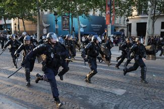 Police disperse Paris Saint-Germain fans on the Champs-Élysées