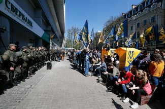 Activists and supporters of Ukrainian nationalist groups block the entrance to a branch of Ukrainian subsidiary of Russian government-owned Sberbank in downtown Kiev, Ukraine on 10 April 2017 in protests demanding that all banks associated with Russia be closed in Ukraine.