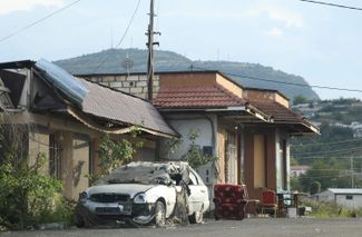 A damaged vehicle and furniture outside a house in Stepanakert. October 2, 2023.