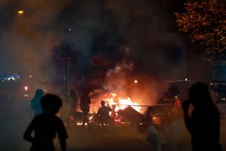 A burning barrier in Paris next to the Arc de Triomphe