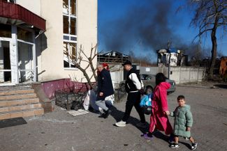 Local residents return to their home in Brovary, which was damaged by a Russian raid, on March 14, 2026.