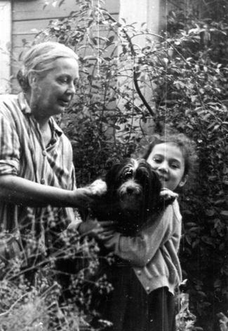 Vera Chaplina with her granddaughter Marina and their dog Julka on a garden plot in Butakovo, 1967