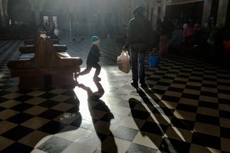 A boy from a family of refugees playing in the waiting hall at the Brest train station. This photograph was taken on November 14, 2016.