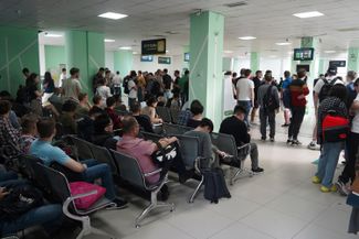 A line of Russians who just arrived in Kazakhstan wait for their ID cards at a public services center in Almaty. September 27, 2022.