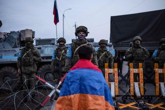 A blockade opponent in front of a Russian peacekeeping checkpoint near Stepanakert. December 24, 2022.