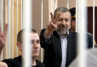 Andrei Sannikov gestures from inside the defendants’ cage during a court hearing in Minsk. May 14, 2011.