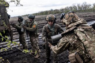 Украинские военные 24-го штурмового батальона сухопутных войск «Айдар» загружают боеприпасы в машину в районе Бахмута