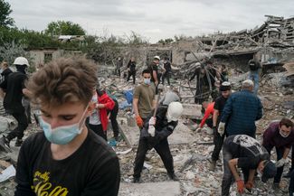 Волонтеры работают на месте, где были уничтожены несколько частных домов