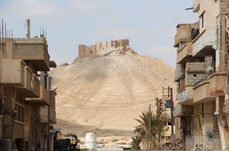 Вид на древнюю цитадель Пальмиры из жилого района города. 27 марта 2016 года