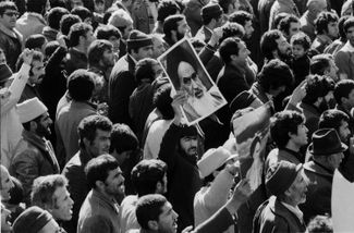 Protesters hold up portraits of Imam Ruhollah Khomeini. January 1979