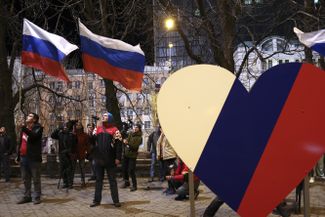 Demonstrators celebrate Russian recognition in separatist-controlled Donetsk on February 21, 2022.