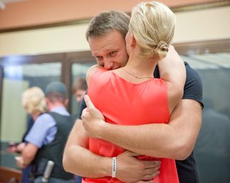 Alexey Navalny and his wife, Yulia, on July 19, 2013, at the Kirov regional court, following a judge’s decision to cancel his arrest (and the arrest of Petr Ofitsevov), a day after a lower court sentenced him to prison. Navalny is released until his prison sentence (which is later reduced to probation) takes effect.
