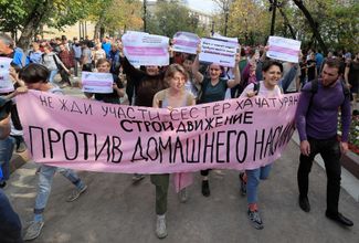 Demonstrators march in Moscow against domestic violence and in support of the <a href="https://meduza.io/en/feature/2019/06/27/it-was-their-lives-or-his" target="_blank">Khachaturyan sisters</a>, who are accused of murdering their abusive father. Their sign reads, “Don’t wait until [you’ve suffered] the fate of the Khachaturyan sisters. Build the movement against domestic violence!” August 31, 2019.