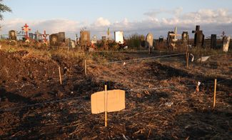 Вид на кладбище в селе Гроза с временными ограждениями для будущих могил. На переднем плане табличка с участком для захоронения четырех человек из семьи Пантелеевых, погибших в результате удара