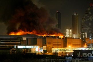 Smoke rises over Crocus City Hall as the concert venue burns