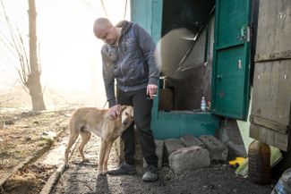 Alexander, a local resident, had his house destroyed by a Russian air bomb in the summer of 2023. He and his dog now live in the basement of a multi-storey building. 