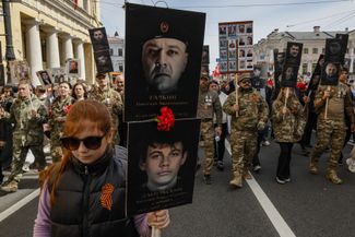 Wagner PMC soldiers and their loved ones hold photos of their comrades during the Regimental Immortal Parade. Saint Petersburg, May 9, 2026