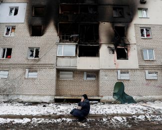 Женщина у разрушенного жилого дома в городе Волноваха Донецкой области