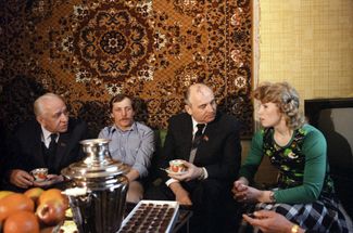 Soviet leader Mikhail Gorbachev and First Secretary of the Moscow City Committee of the Communist Party Viktor Grishin (far left) visiting the home of a Moscow family. April 18, 1985. 