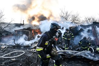 Rescuers extinguish a fire after a Russian air strike in Zaporozhye, March 14, 2026.