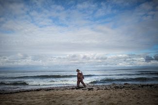 A woman searches for amber washed ashore on the beaches of the Baltic Sea in Kaliningrad region