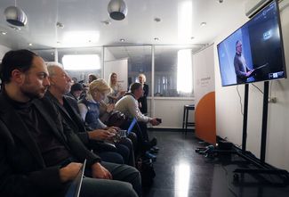Open Russia workers in Moscow watch an online press conference given by Khodorkovsky. December 9, 2015