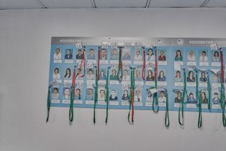 Portraits of doctors on the wall of the intensive care unit in the “red zone.” When coming in for a shift, a doctor will put on their badge, and then hang it on the stand when they leave.