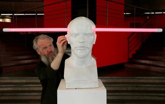 Василий Слонов чистит свою работу под названием «Светлые идеи. Ленин» в музейном центре «Площадь Мира» в Красноярске. 2018 год