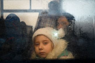 A girl inside a bus that had crossed the checkpoint on the Moldovan-Ukrainian border. The bus was carrying refugees to Chisinau.