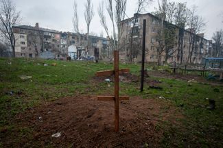 The grave of a resident of Bakhmut, who was killed in another Russian airstrike.  Cemetery arranged right next to residential buildings