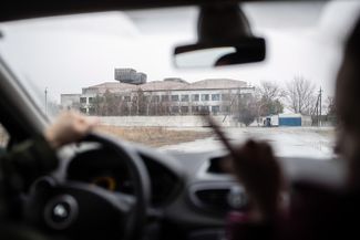 A friend drives Dasha from the supermarket to the prison. This is the barrack where Egor lives. The bunk beds inside and partially broken windows can be seen from the road.