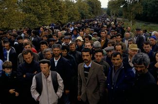 Georgian refugees who fled Abkhazia for Zugdidi stand on the Zugdidi side of the bridge marking the new frontier with the separatist region. October 1993.