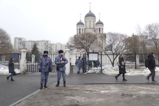 Police stand near the Church of the Icon of Our Lady Soothe My Sorrows
