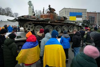 A crowd gathers around a destroyed Russian tank, installed to mark the first anniversary of Russia’s full-scale invasion of Ukraine. Tallinn, Estonia. February 25, 2023.
